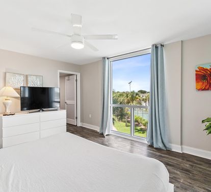 Wake up to serene views of lush greenery from your comfortable bedroom, complete with modern entertainment and peaceful natural light.