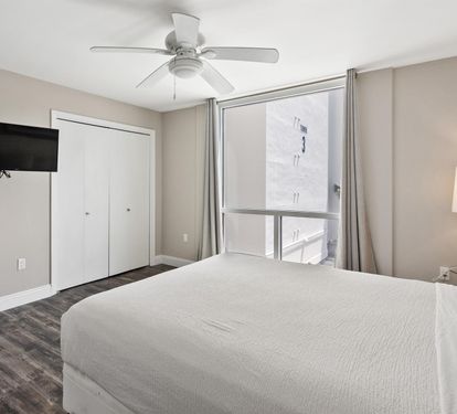 Rest peacefully in your bright, modern bedroom with cooling ceiling fan, flat-screen TV, and city views from your window.