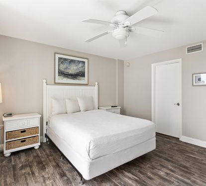 Drift into peaceful sleep in your serene bedroom featuring crisp white linens and coastal charm.