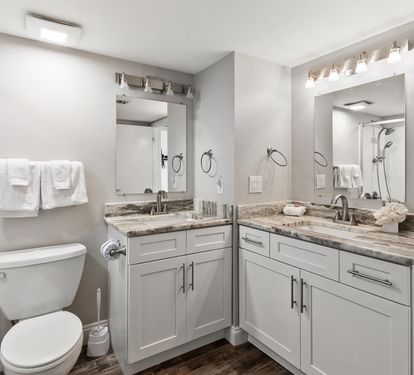 Pamper yourself in this luxurious bathroom with double vanities, marble countertops, and fresh white towels waiting for your arrival.