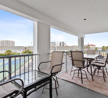 Unwind on your private balcony with comfortable seating and sweeping views of the city skyline and nearby coastline.