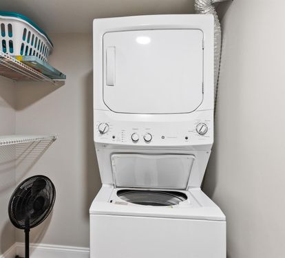 Your private laundry closet features a stacked washer and dryer with convenient shelving for all your vacation essentials.