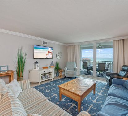 Unwind in your bright oceanfront living room with plush seating, nautical touches, and stunning balcony views that invite endless relaxation.
