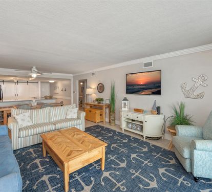 Relax in your coastal-themed living space with comfortable seating, ocean artwork, and nautical touches that make you feel right at home.
