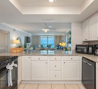 Your fully equipped kitchen opens to ocean views, with granite counters and all appliances for preparing beachside meals.