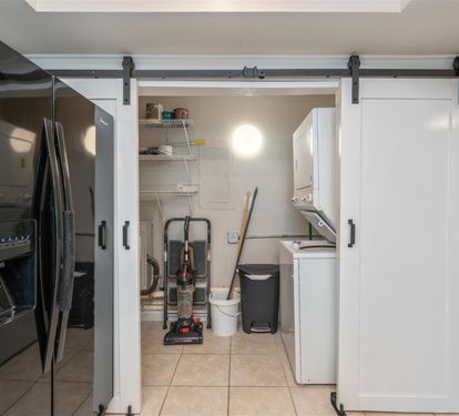 Your fully-equipped kitchen features modern appliances and a convenient laundry closet with sliding barn doors for seamless meal prep and easy cleanup.