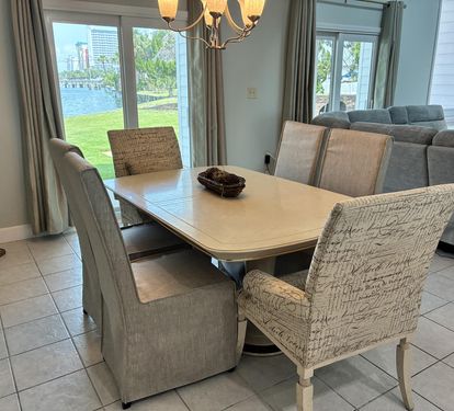 Gather around this elegant dining table where waterfront views create the perfect backdrop for your memorable meals together.