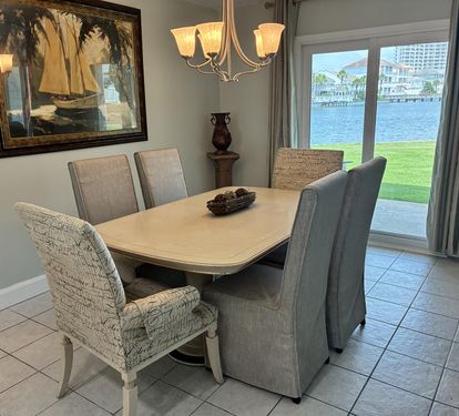 Enjoy memorable meals at your elegant dining table while gazing out at stunning waterfront views through your private patio doors.