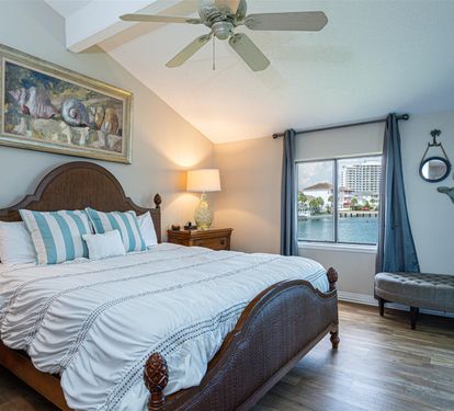 Drift off to sleep in your coastal-themed bedroom, where gentle ceiling fan breezes and waterfront views create the perfect retreat.
