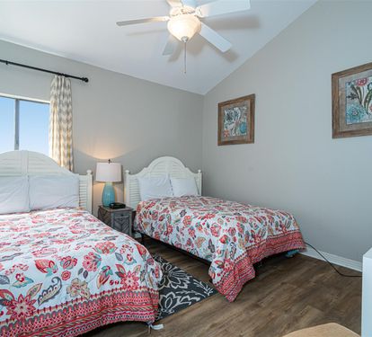 Drift off to sleep in twin beds with cheerful paisley linens, while your ceiling fan keeps you cool and comfortable all night long.