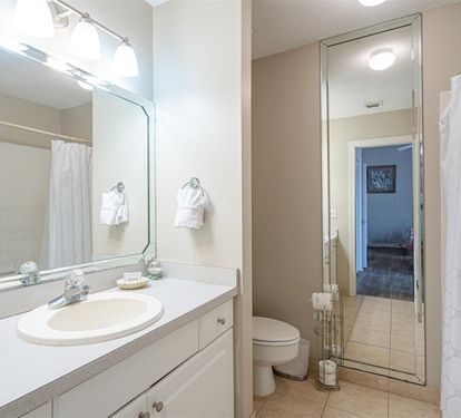 Step into your private bathroom sanctuary with bright vanity lighting, fresh towels, and everything you need for a refreshing start to your day.
