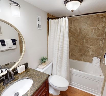 Step into your spa-like bathroom with elegant granite counters, beautiful tile work, and plush towels waiting for your arrival.