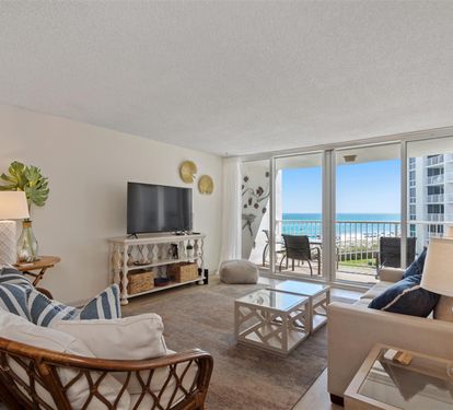 Relax in your coastal living room with stunning ocean views from the private balcony. Comfortable seating and beach-inspired decor create your perfect seaside retreat.