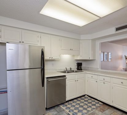 Your fully equipped kitchen features stainless steel appliances and bright white cabinetry, perfect for preparing meals during your stay.