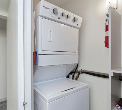 Your in-unit washer and dryer combo keeps your clothes fresh throughout your stay, conveniently tucked away in this clean, organized space.