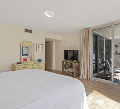 Wake up to ocean breezes in your coastal bedroom, where sliding doors open to your private balcony and comfort meets seaside charm.