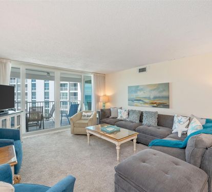 Unwind in this bright living space featuring a plush sectional sofa and coastal décor that creates your perfect retreat atmosphere.