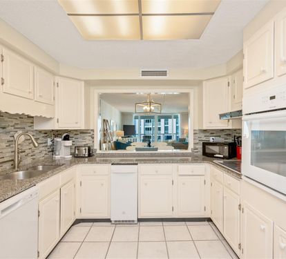 Cook your favorite meals in this fully equipped kitchen featuring granite counters and modern appliances.