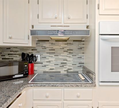 Your modern kitchen features granite counters, glass tile backsplash, and full appliances for easy meal prep.