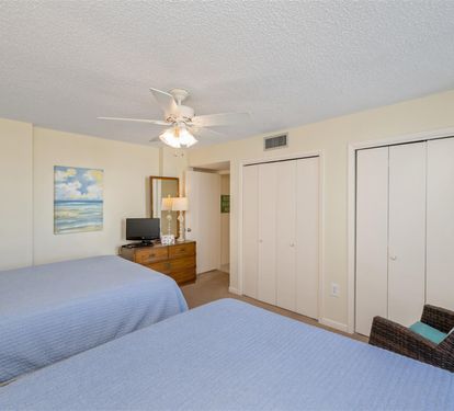 Drift into peaceful dreams in your beach-themed bedroom, complete with twin beds and coastal artwork.