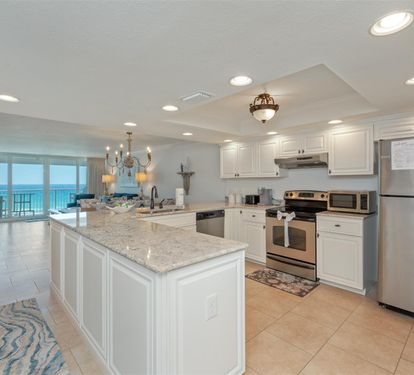 Your fully equipped kitchen features granite counters, stainless appliances, and opens to breathtaking ocean views.