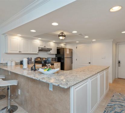 Cook like you're at home in this bright kitchen with granite countertops and modern appliances.