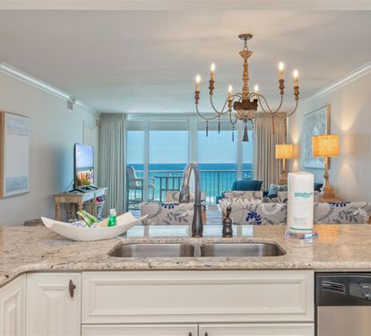 Your gourmet kitchen overlooks stunning turquoise waters, where granite counters and coastal views create the perfect backdrop for morning coffee or evening cocktails.