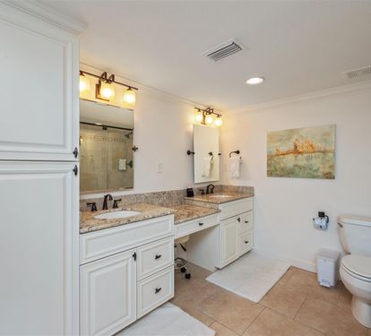 Step into your spacious master bathroom featuring elegant dual vanities, granite countertops, and beautiful natural light for your morning routine.
