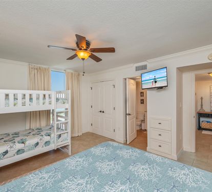 Sleep soundly in your coastal bedroom with bunk beds for the kids and an ocean-themed queen bed, complete with ceiling fan and TV for comfort.