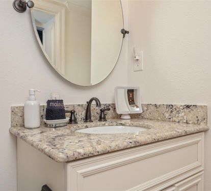 You'll love getting ready each morning at this elegant vanity with granite countertops and thoughtful amenities.