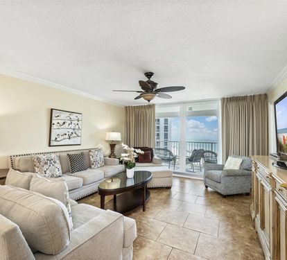 Relax in your elegant living room with plush seating and stunning ocean views from your private balcony.
