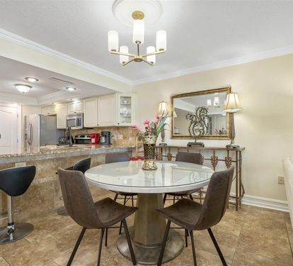 Gather around your elegant glass dining table for memorable meals in this beautifully appointed space with modern fixtures and sophisticated décor.