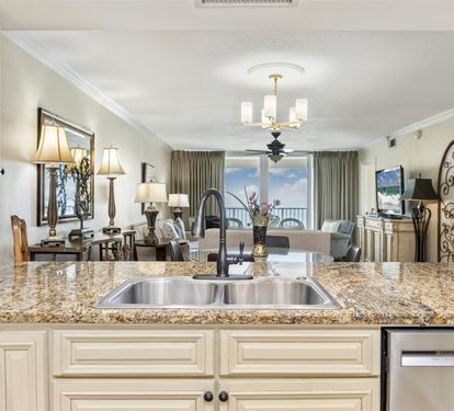 Cook your favorite meals in this elegant kitchen with granite counters and ocean views beyond.