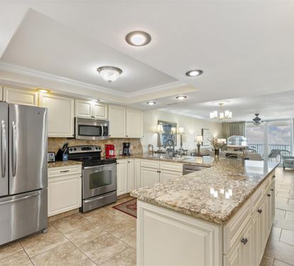 Your spacious kitchen features gleaming granite counters and stainless appliances, perfect for preparing meals during your stay.
