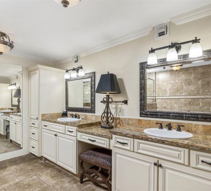 Luxurious dual vanity bathroom with granite counters and elegant lighting creates your perfect morning routine sanctuary.