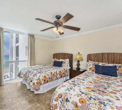 Wake up to stunning ocean views from your comfortable twin bedroom, where coastal breezes from your private balcony create the perfect beachside retreat.