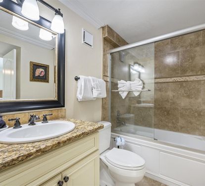 Unwind in your beautifully appointed bathroom featuring elegant granite counters, fresh towels, and a luxurious tub-shower combo.
