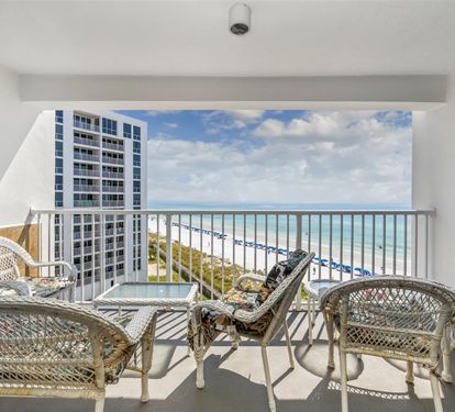 Relax on your private balcony with comfortable wicker seating while taking in stunning ocean and city views.