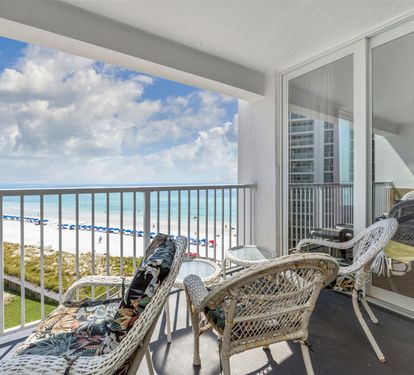 Unwind on your private balcony with stunning ocean views, comfortable wicker seating, and endless blue horizons stretching before you.
