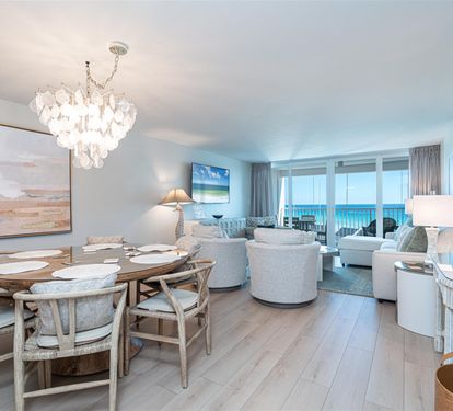 Relax in this stunning oceanfront living space where elegant coastal decor meets breathtaking sea views from your private balcony.