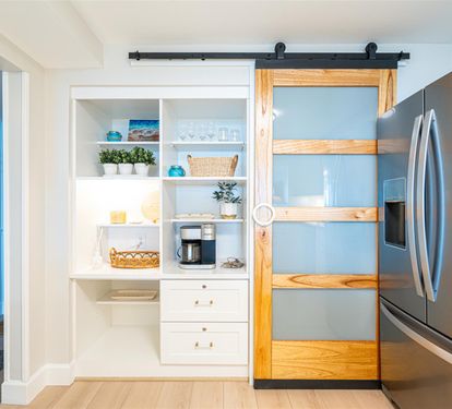 Your stylish pantry features a charming barn door and organized shelving, perfect for storing snacks and cooking essentials during your stay.