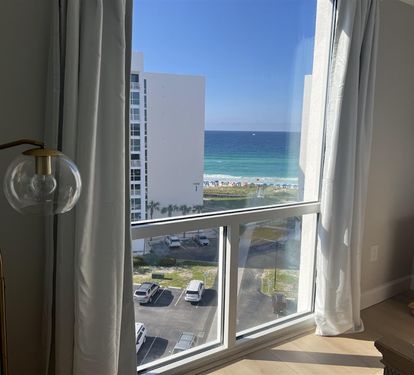 Wake up to stunning ocean views framed by floor-to-ceiling windows in your bright, comfortable room.