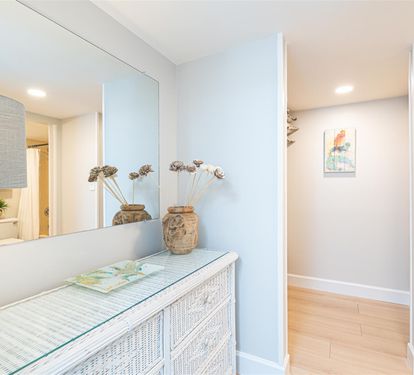 Step into your serene hallway where coastal charm meets modern comfort—natural textures and soft lighting create a welcoming atmosphere.