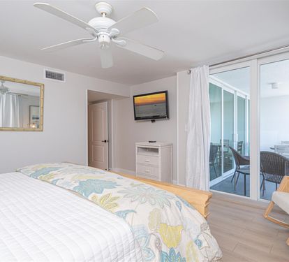 Drift off in your coastal bedroom with tropical bedding and private balcony access for morning coffee in paradise.