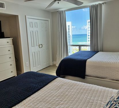 Wake up to stunning ocean views from your comfortable bedroom, where twin beds and modern furnishings create the perfect coastal retreat.