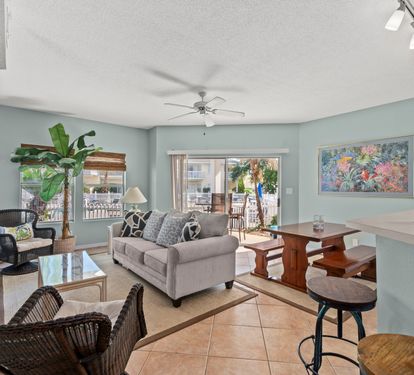 Sink into the plush sofa and enjoy your tropical oasis with calming décor, modern amenities, and peaceful balcony views.