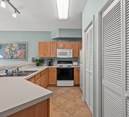 Your fully equipped kitchen features modern appliances and ample counter space for preparing delicious meals during your beach getaway.