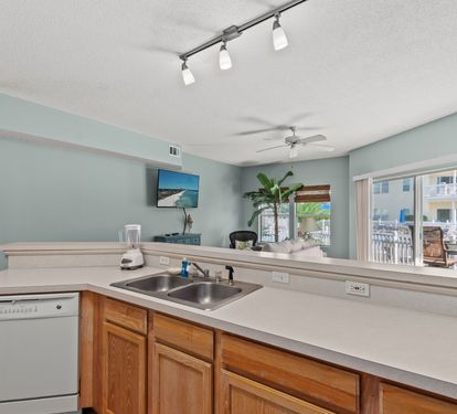 Your open kitchen flows seamlessly into the living area, with views of the pool deck creating the perfect space for vacation cooking.