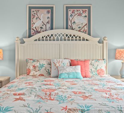 Drift off in your coastal bedroom with ocean-inspired bedding, warm lighting, and elegant botanical artwork creating perfect seaside serenity.