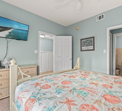 Drift off to sleep in your coastal-themed bedroom, complete with ocean-view TV and private bathroom access.